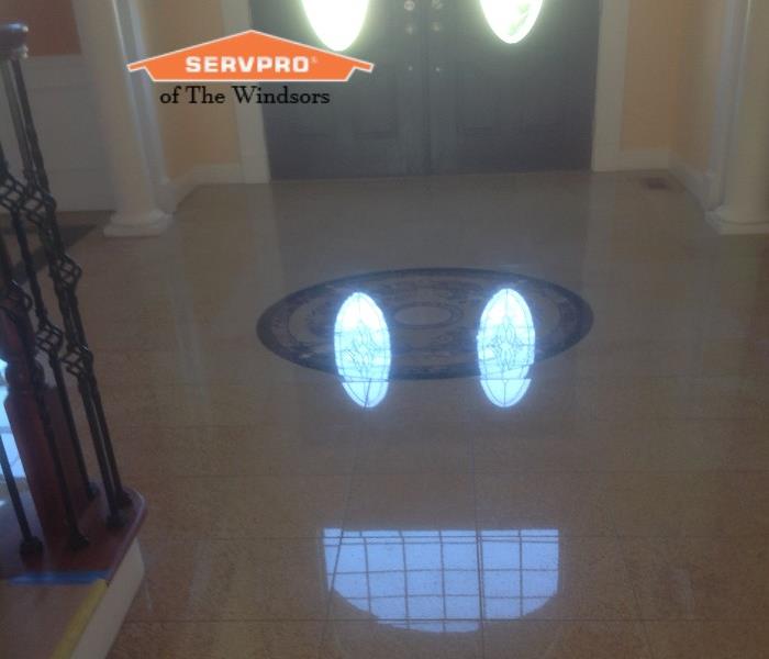 south windsor home, tile floors, fire cleaning done, reflection from sun making smile face, SERVPRO logo