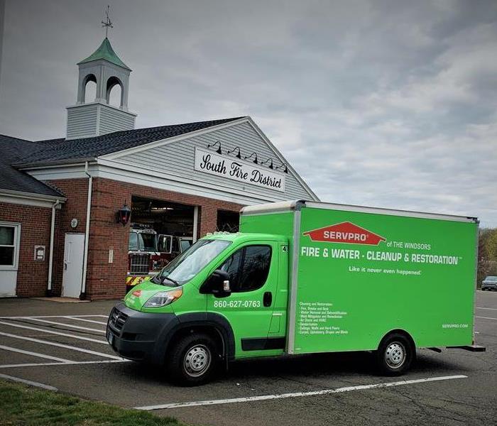 servpro of the windsors truck at fire house, blue skies, front of building, middletown fire, cleanup